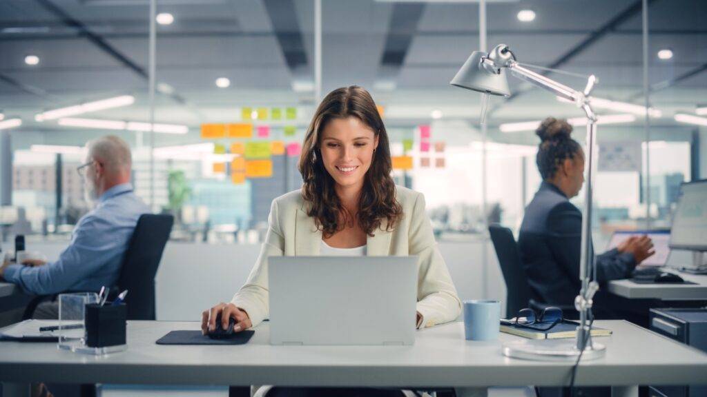 Smiling young female professional working in an office