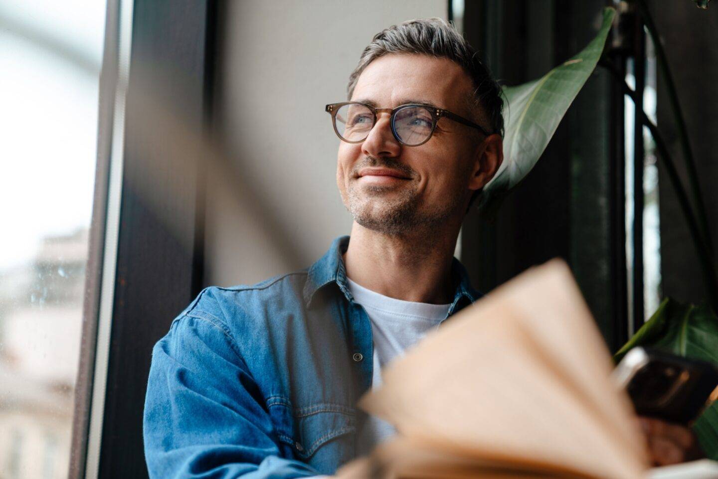 Happy man looking out a window