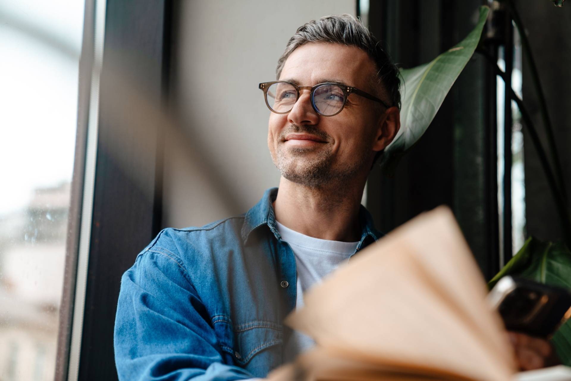 Happy man looking out a window