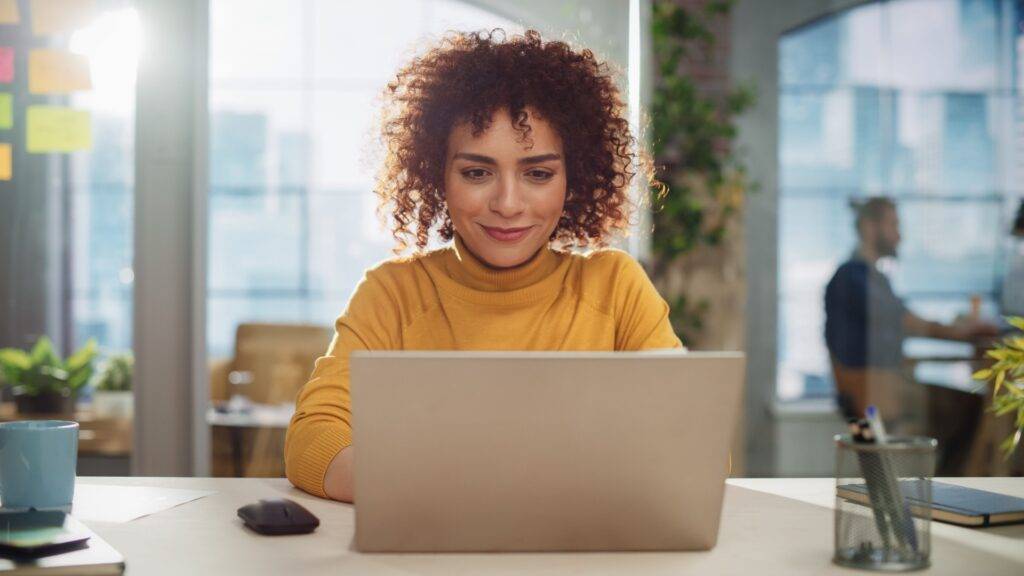 Female professional working at a laptop in an office