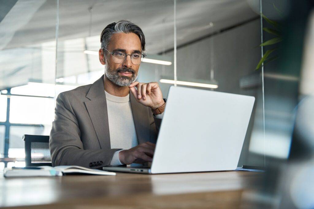 Older male professional focused at work in an office
