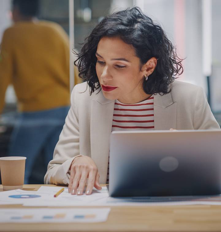 Focused female professional looking at documents in an office