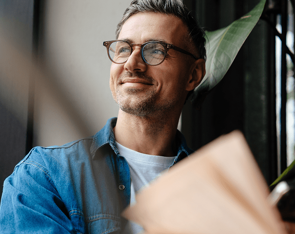 Smiling map looking out of a window